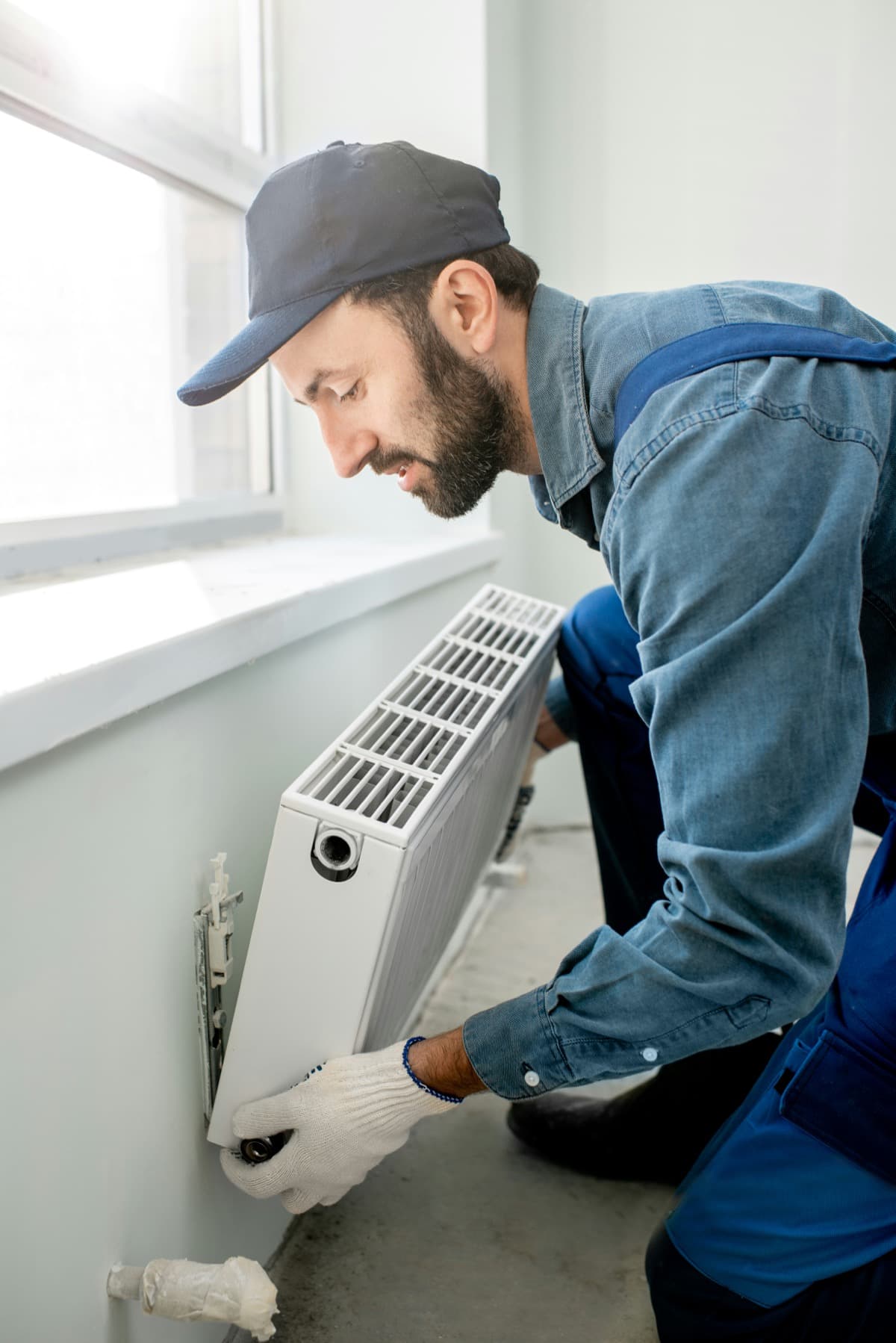 HVAC technician installing a heating unit in a Bay Area home