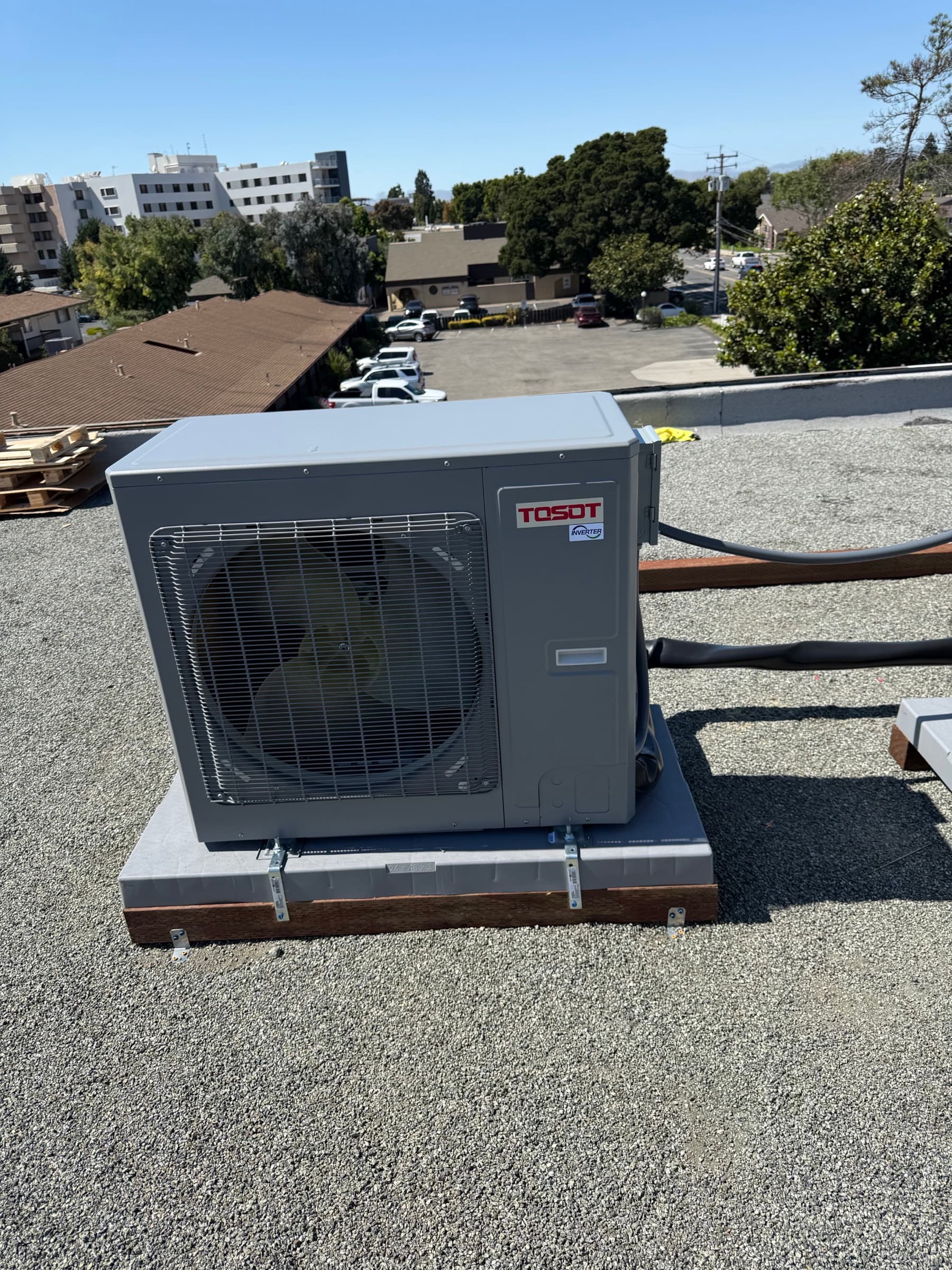 TOSOT condenser unit secured on a flat roof