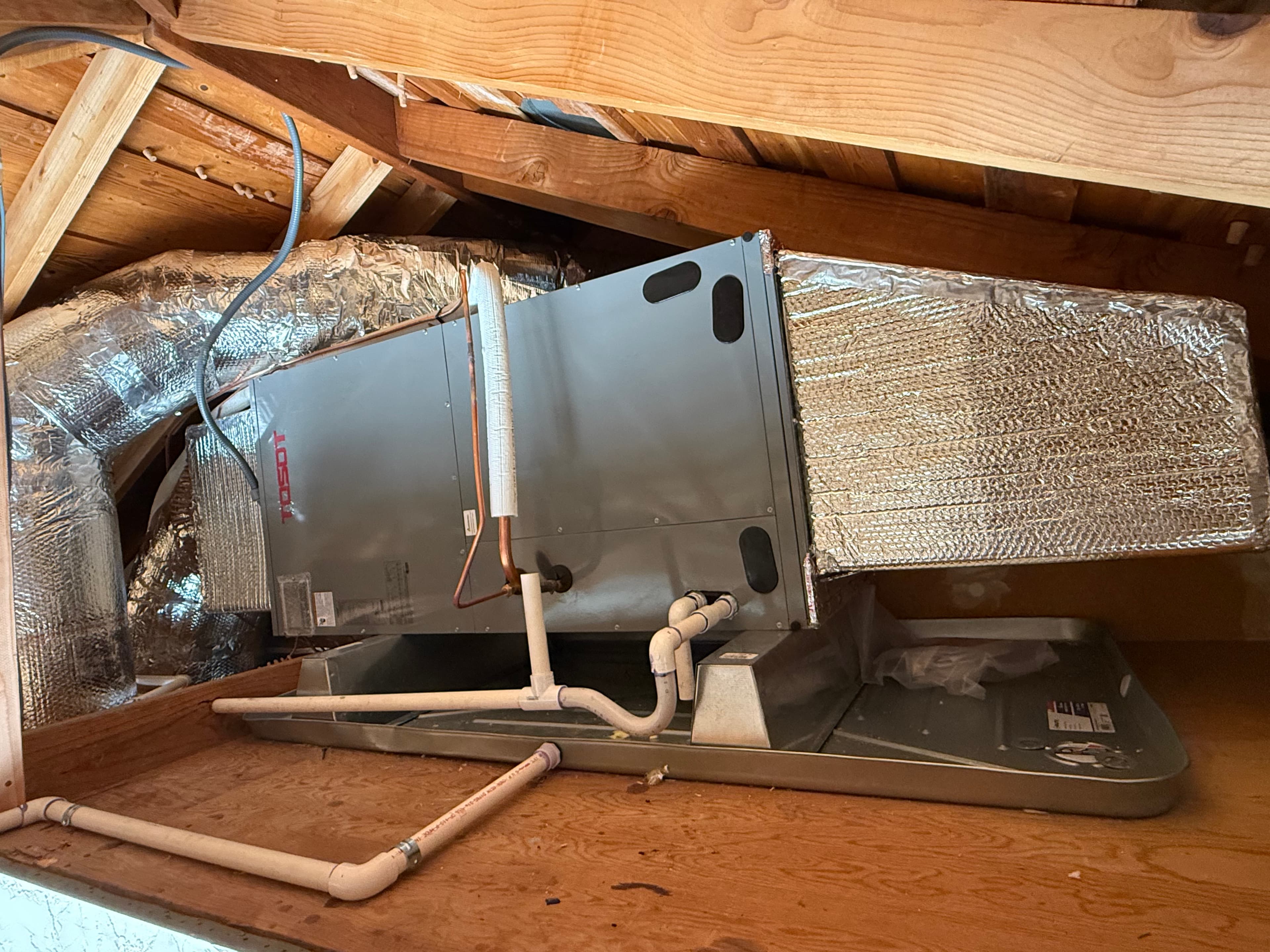 Air handler with insulated ductwork in attic